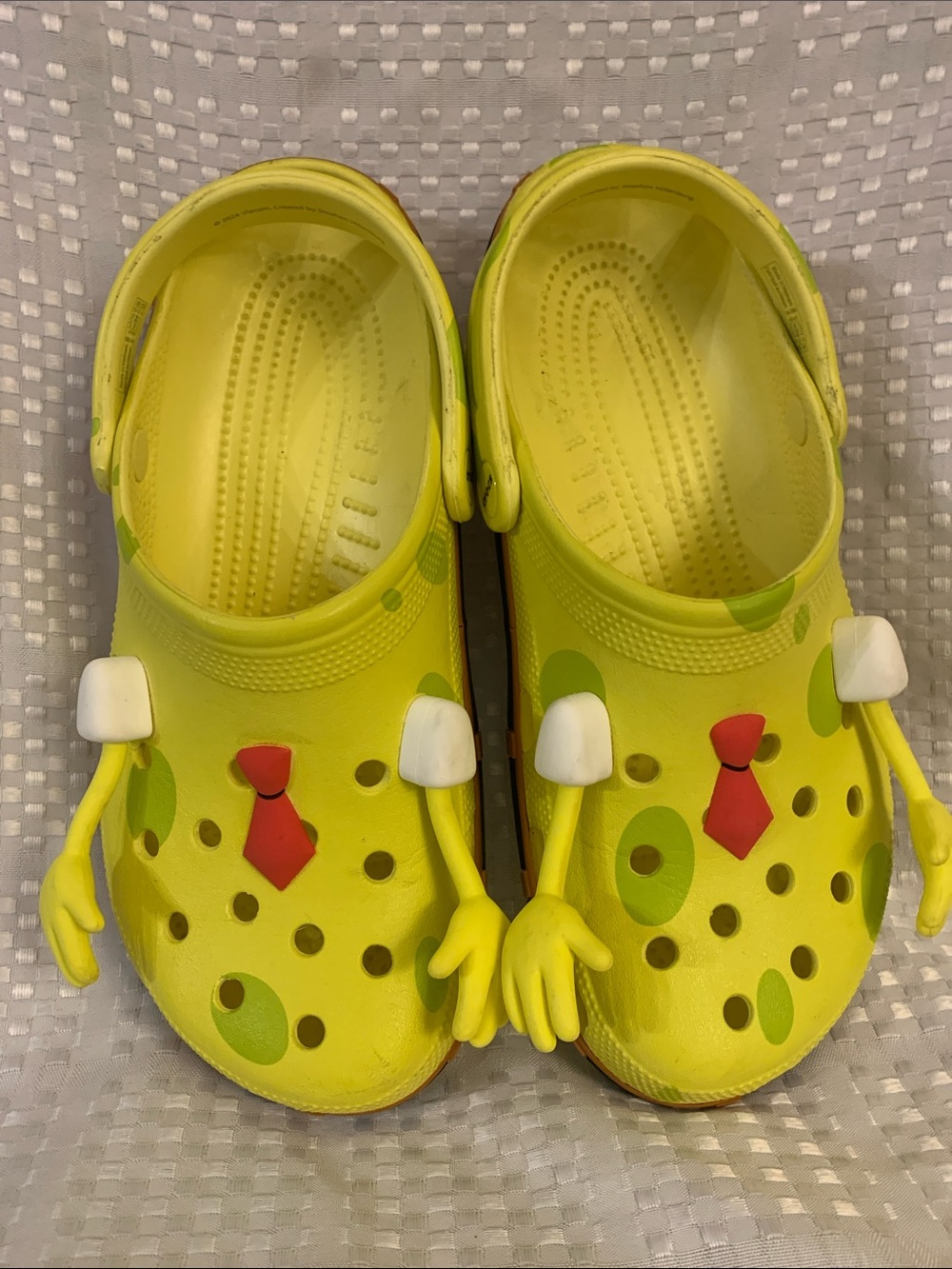 SpongeBob SquarePants CROCS, yellow with SpongeBob designs, men’s 9, women’s 11.